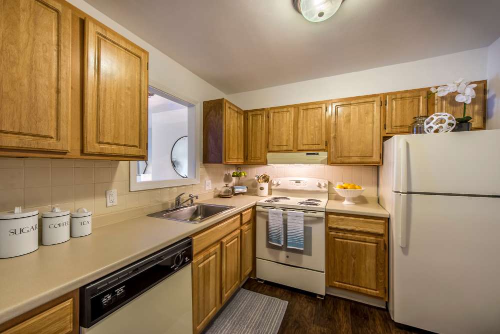 Fully equipped kitchen with white appliances at Fairlawn Estates at the T in Mattapan, Massachusetts