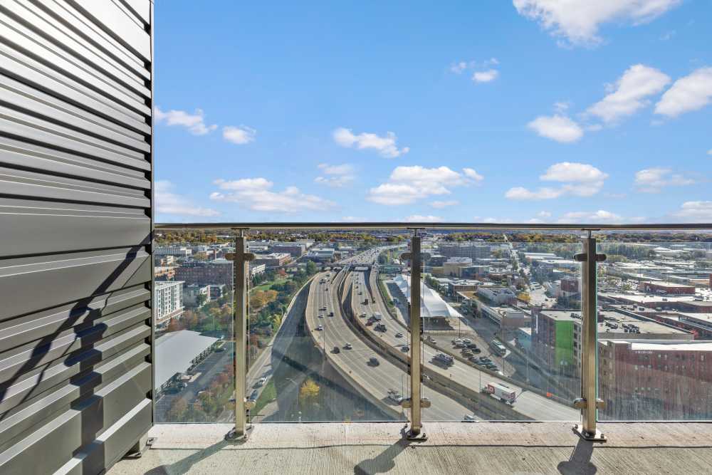 Balcony view of highway and cityscape under clear blue sky at Studio Park Tower & Lofts in Grand Rapids, Michigan