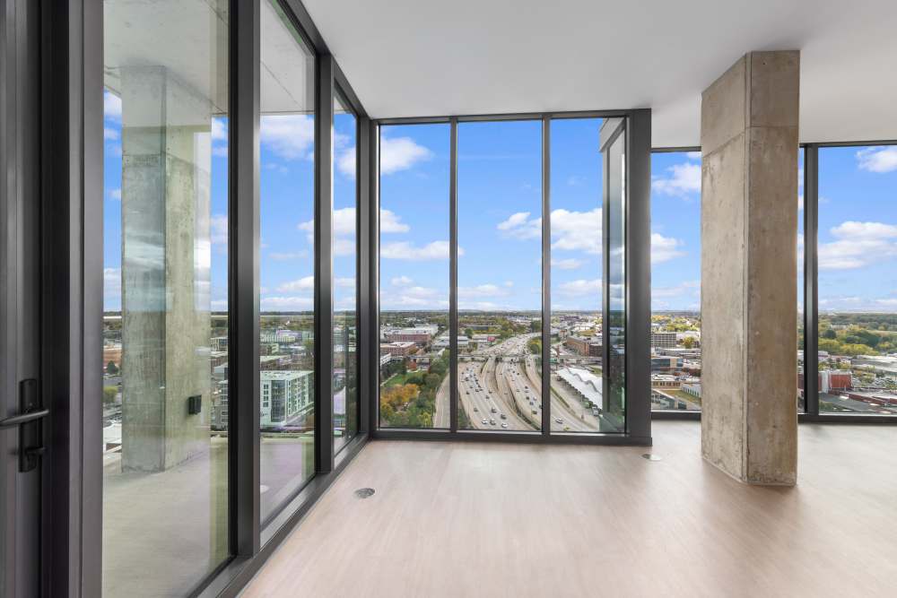 Glass‑walled nook with expansive views of city and highway at Studio Park Tower & Lofts in Grand Rapids, Michigan