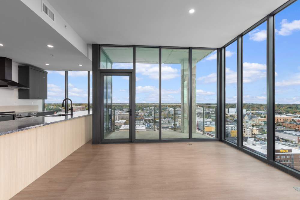 Dining area by balcony door with sweeping city views at Studio Park Tower & Lofts in Grand Rapids, Michigan