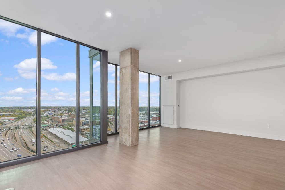 Bright corner room with tall windows overlooking city and highway at Studio Park Tower & Lofts in Grand Rapids, Michigan