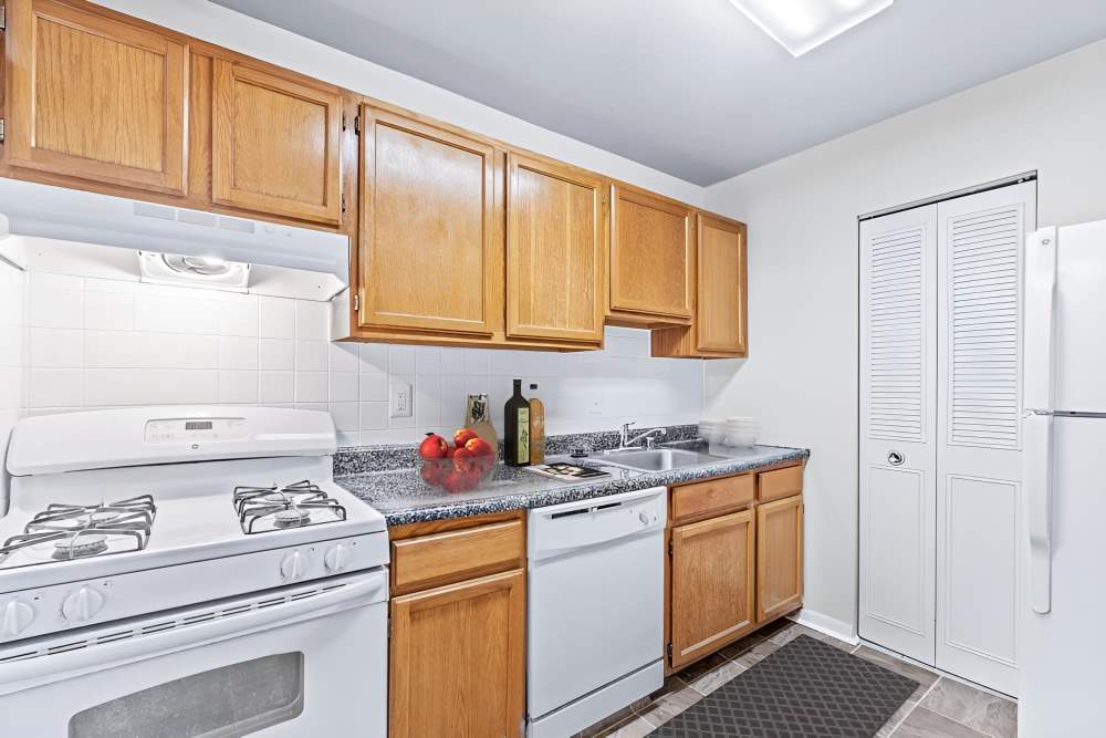 Kitchen with wooden cabinets at Fox Club in Capitol Heights, Maryland