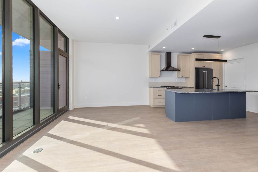Open living and kitchen area with balcony windows at Studio Park Tower & Lofts in Grand Rapids, Michigan