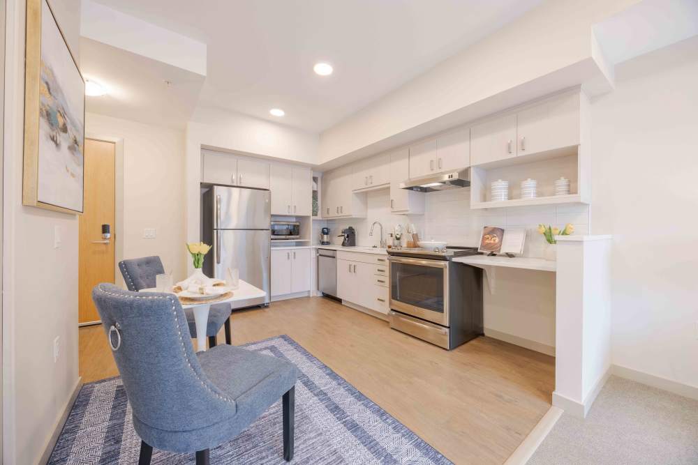 Cozy bedroom with large comfortable bed at Merrill Gardens at Sherwood in Sherwood, Oregon, 