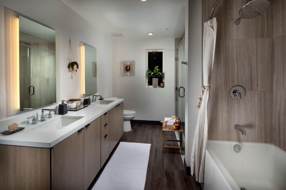 Bathroom with frameless vanity mirror at Haven Apartments in Los Angeles, California