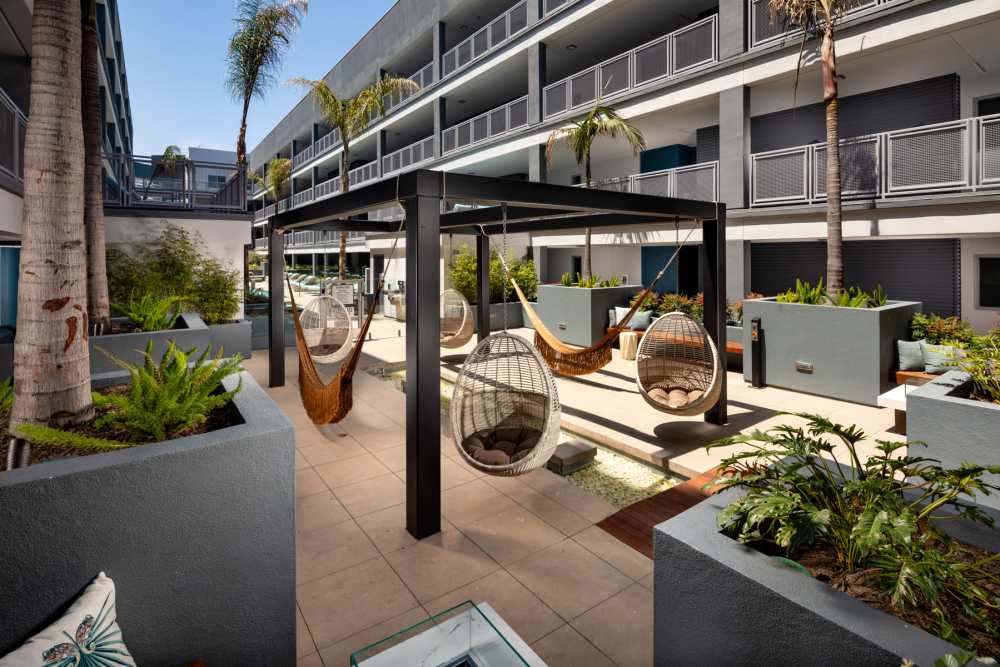 Courtyard with swing chair at Haven Apartments in Los Angeles, California