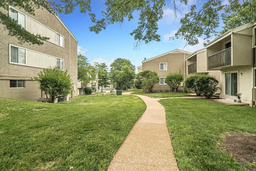 Apartment backyard with pathway at Waterford West in Manchester, Missouri