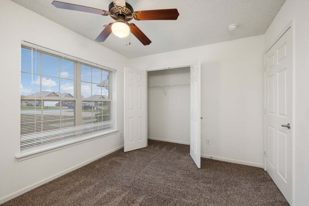 Unfurnished bed room with carpet flooring and open closet at Oaklawn II in Rogersville, Missouri 