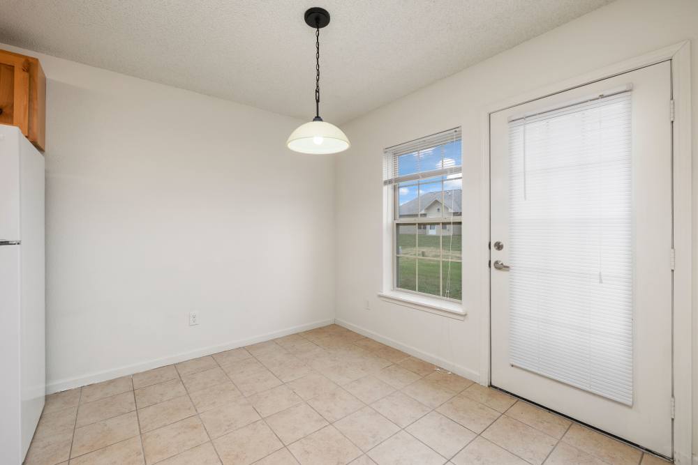 Dining area and access to kitchen and living at Oaklawn II in Rogersville, Missouri 