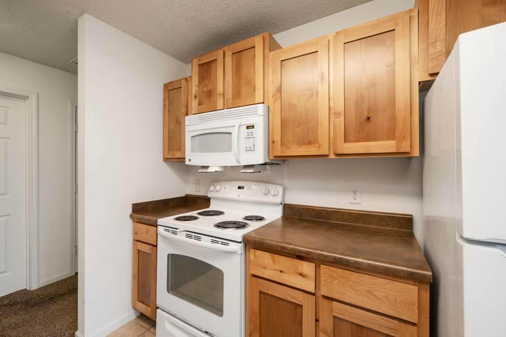 Kitchen with wood cabinets and access to kitchen at Oaklawn II in Rogersville, Missouri 