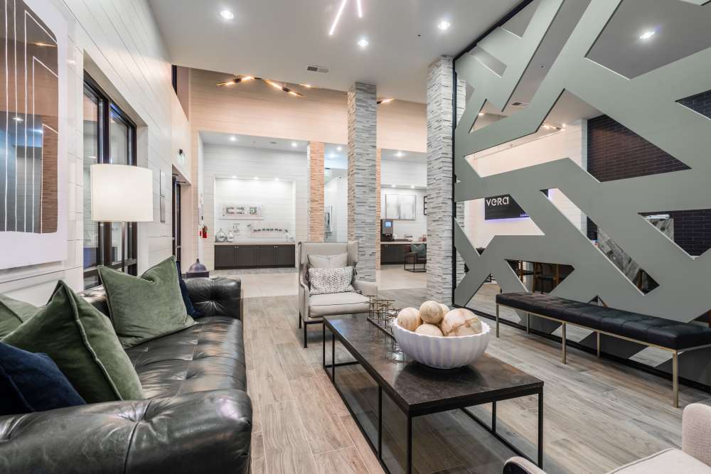 Modern lobby with contemporary seating and decorative room dividers at The Walton in Sanford, Florida.