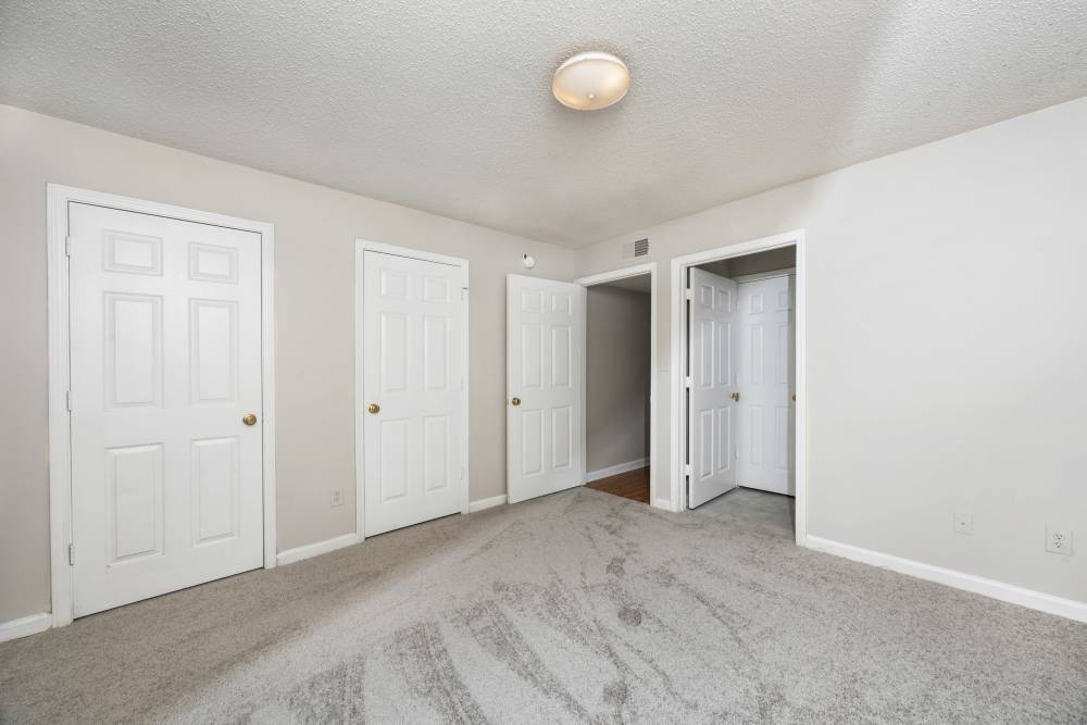 Bedroom with carpet flooring with access to living area at Livingston Oaks in Birmingham, Alabama 