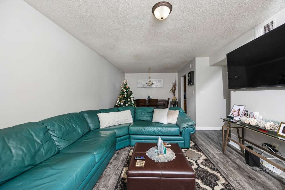 Living and dining area with with wall-mounted TV at Livingston Oaks in Birmingham, Alabama