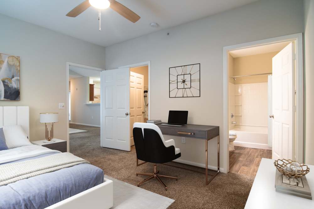 Resident bedroom with plush carpeting at Houston Lake Apartments in Kathleen, Georgia