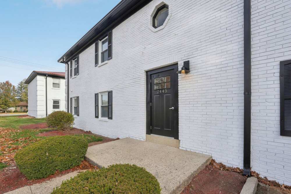 front entry of building with black door at Charleston Square Apartments in Columbus, Indiana