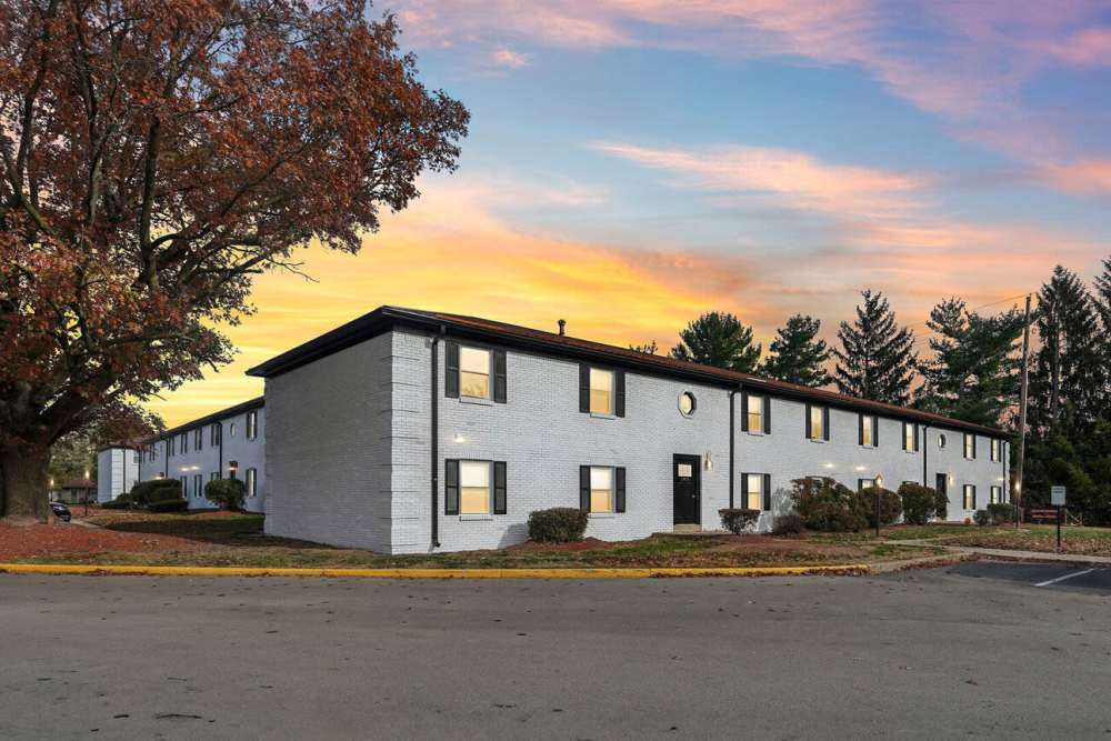 Exterior side view apartment and autumn tree sunset sky at Charleston Square Apartments in Columbus, Indiana