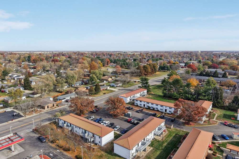 Aerial view of apartments with parking lots, and autumn trees at Charleston Square Apartments in Columbus, Indiana