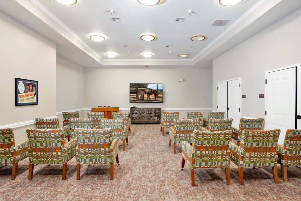 Reception desk with wall art and warm lighting in the lobby, at Sky Vista in Mesa, Arizona