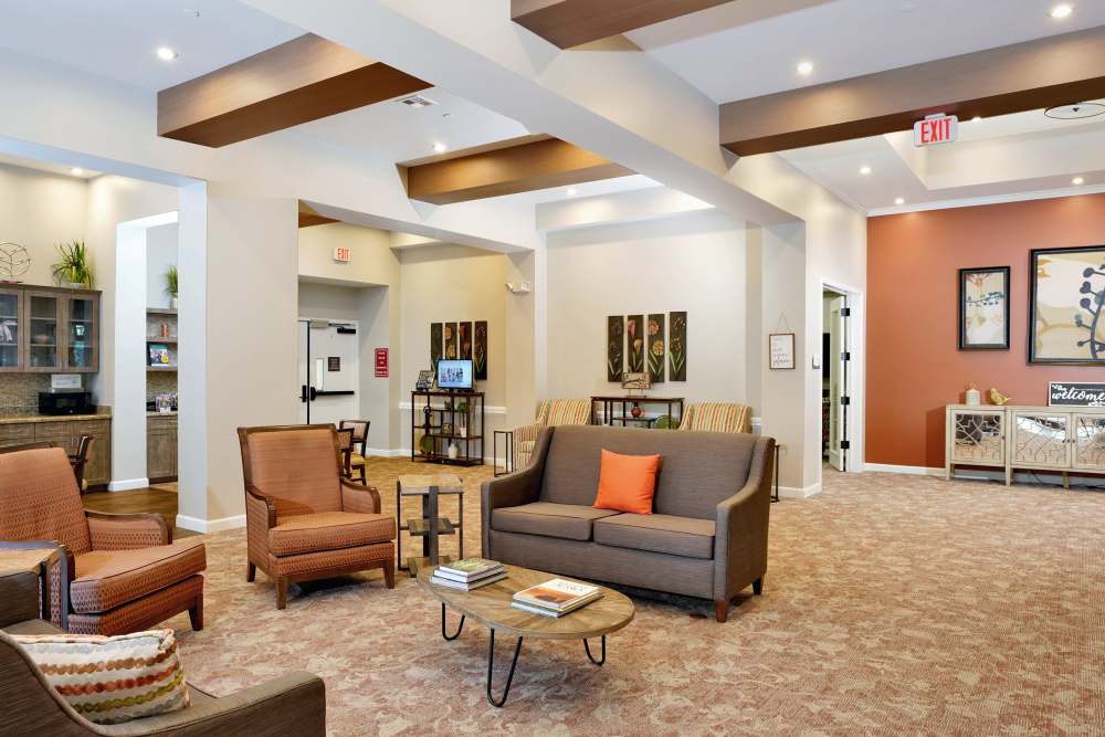 Indoor lounge opening to an outdoor patio with seating, at Sky Vista in Mesa, Arizona