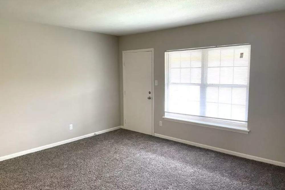 Well-lit bedroom with a large window at The Sycamores in Indianapolis, Indiana 
