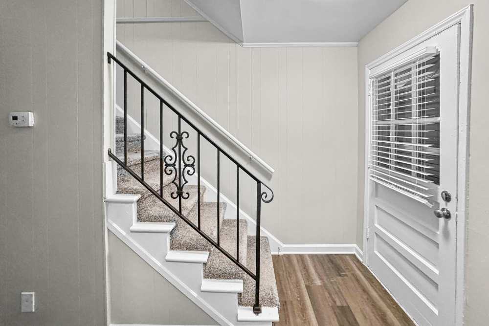 Living room with stairs for access at Pine Ridge at Reynolda in Winston-Salem, North Carolina