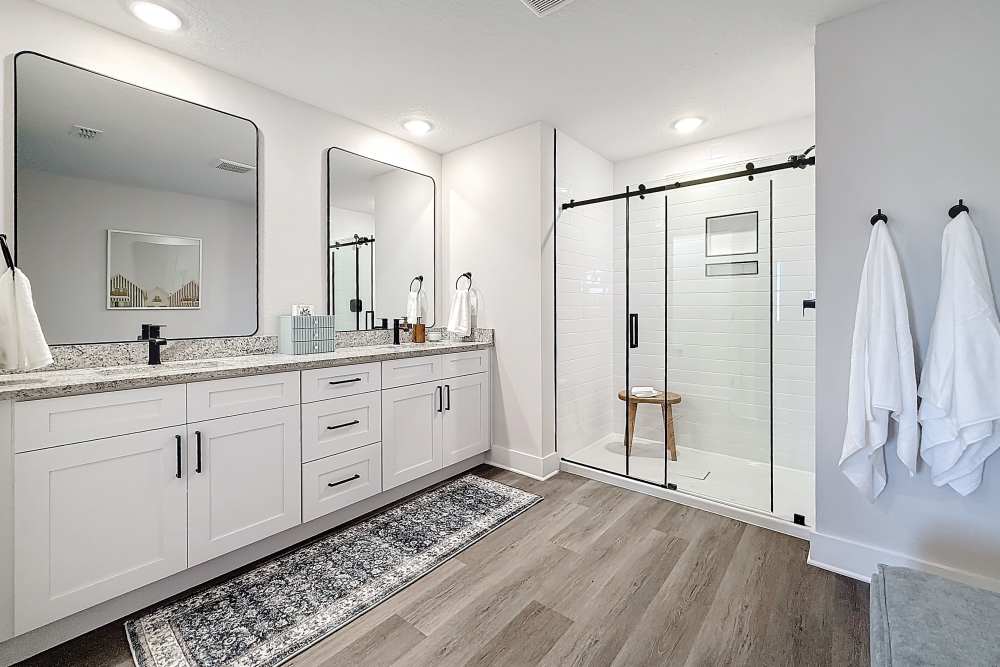 Bathroom with dual vanity and walk-in shower at BB Living at Lakewood Ranch in Lakewood Ranch, Florida