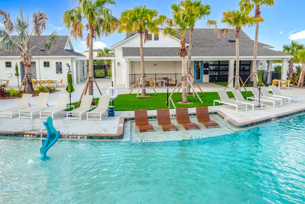 Amenity swimming pool with Lounges and Trees at BB Living at Lakewood Ranch in Lakewood Ranch, Florida