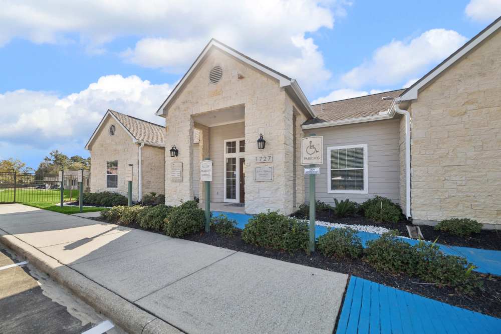 Beautiful exterior view of the community center at Palm Garden in Orange, Texas