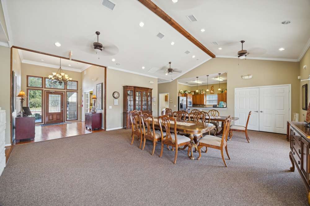 Spacious community dining area with wooden tables at Palm Garden in Orange, Texas