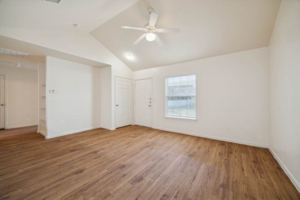 Unfurnished living room with window and ceiling fan at Palm Garden in Orange, Texas