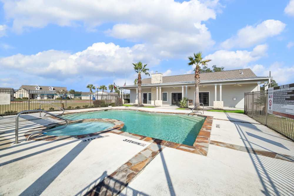 Outdoor swimming pool and clubhouse at Palm Garden in Orange, Texas