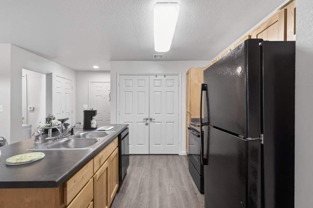 Kitchen with black appliances at Hill Court Villas in Granbury,Texas