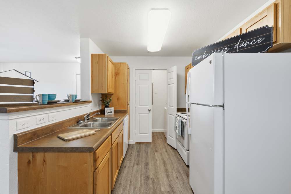 Upgraded kitchen with modern appliances and warm wood accents at Riverside Park in Early, Texas