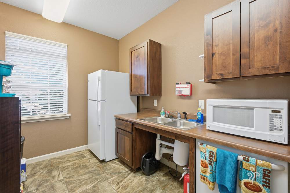 Cozy kitchen with modern appliances and warm wood cabinets at Riverside Park in Early, Texas