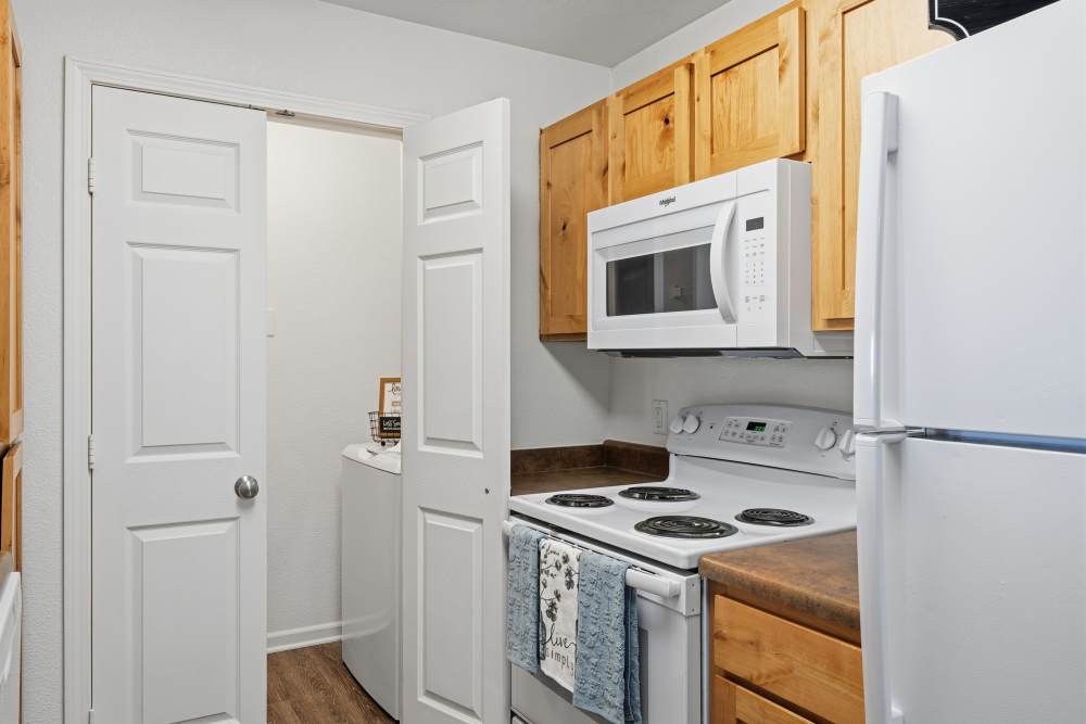 Cozy kitchen with wooden cabinets and modern appliances at Riverside Park in Early, Texas