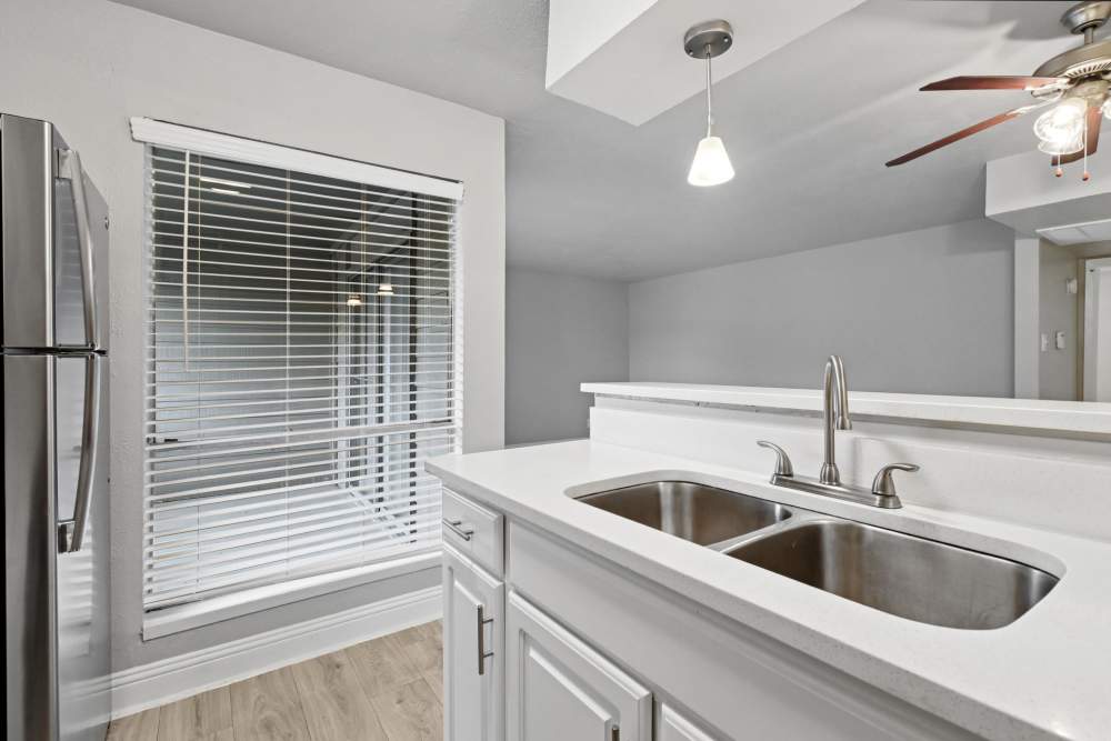 Wide, dual sink in an apartment kitchen at Avondale Parc at Bellmar in Dallas, Texas
