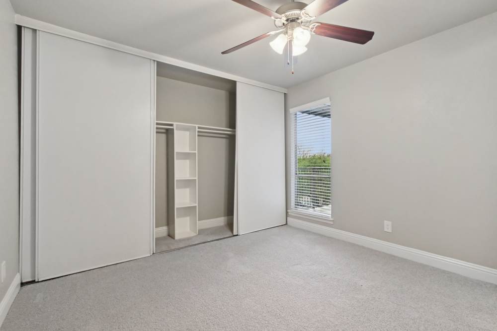 Unfurnished bedroom with plenty of storage at Avondale Parc at Bellmar in Dallas, Texas