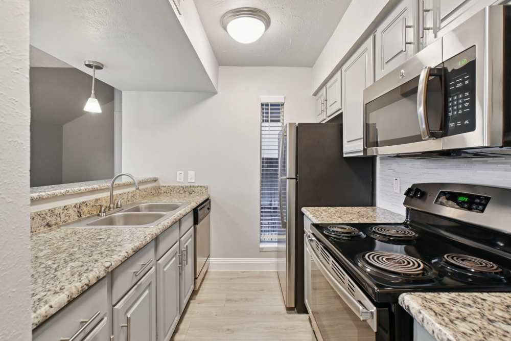 Galley-style kitchen at Avondale Parc at Bellmar in Dallas, Texas