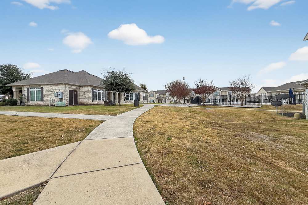 Sidewalk with lawn at Riverstone Trails in Sunnyvale, Texas