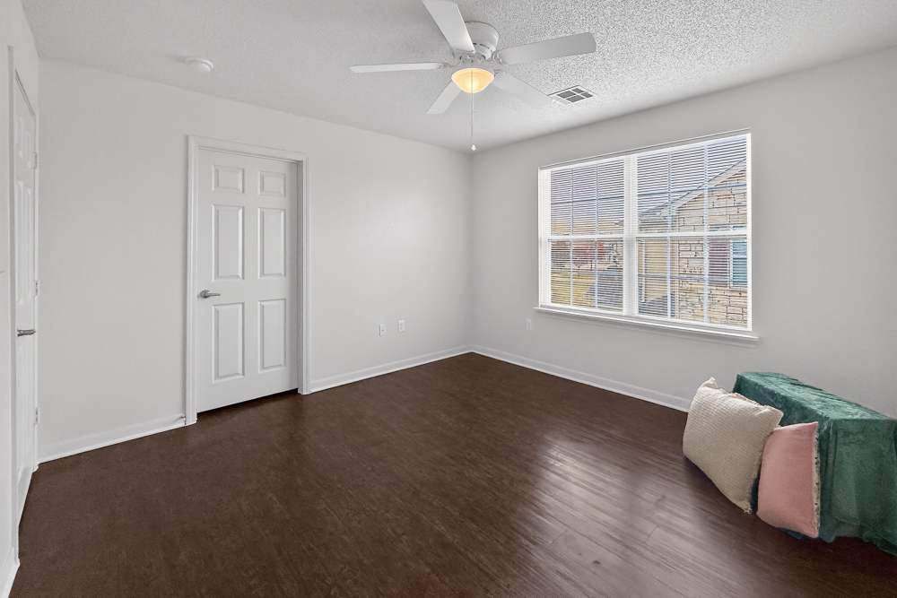 Bedroom with large window at Riverstone Trails in Sunnyvale, Texas 
