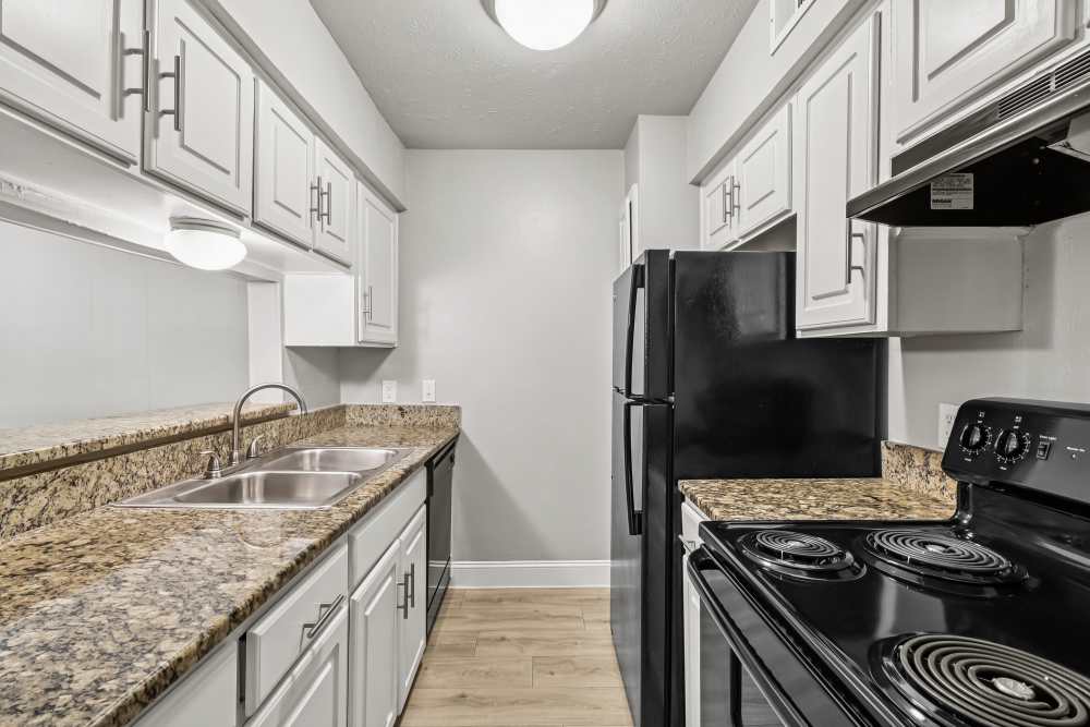 Well-equipped kitchen with black appliances at Aberdeen at Bellmar in Dallas, Texas