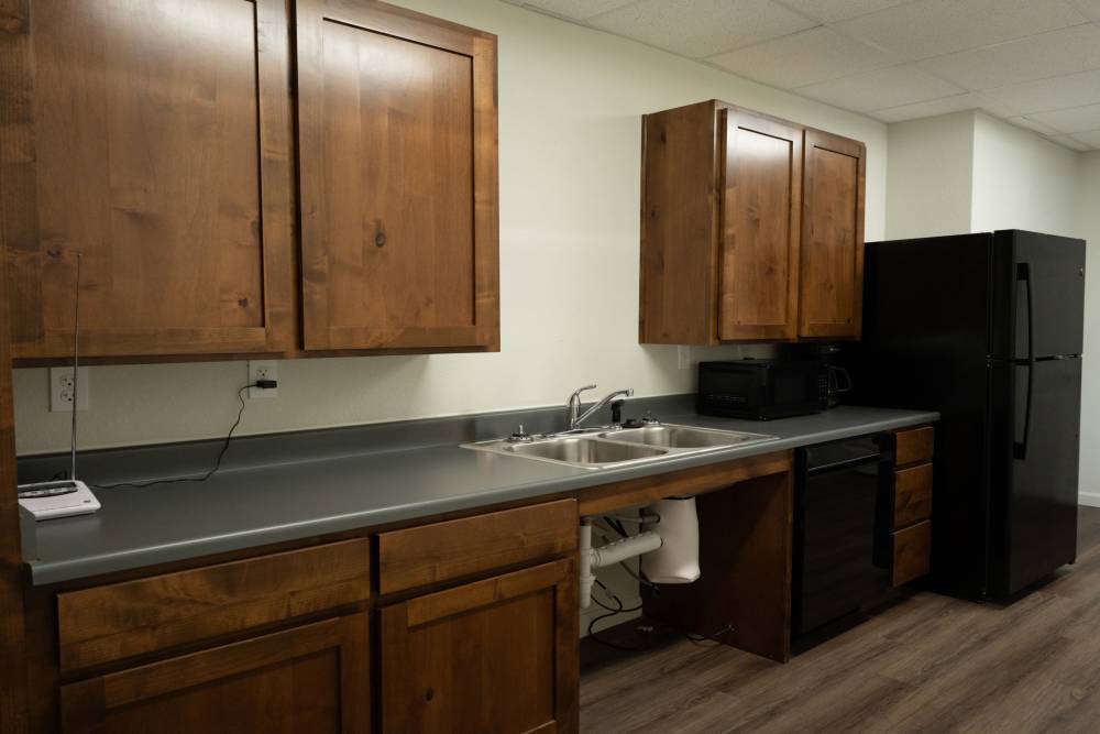 Upgraded kitchen with wooden cabinets and sleek countertops at Savannah Terrace in Mustang, Oklahoma