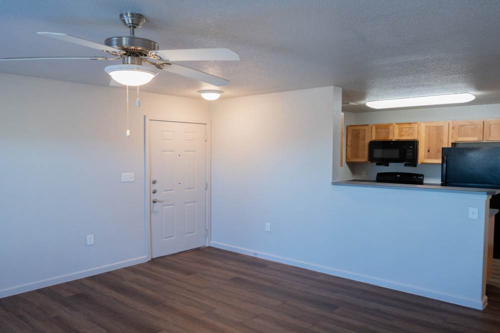Spacious living room with modern kitchen and welcoming entryway at Savannah Terrace in Mustang, Oklahoma
