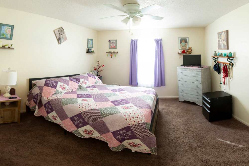 Model bedroom with comfortable bed at Stonebridge in Jacksonville, Illinois