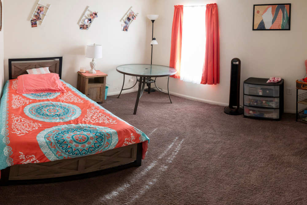 Bedroom with single bed and windows at Stonebridge in Jacksonville, Illinois