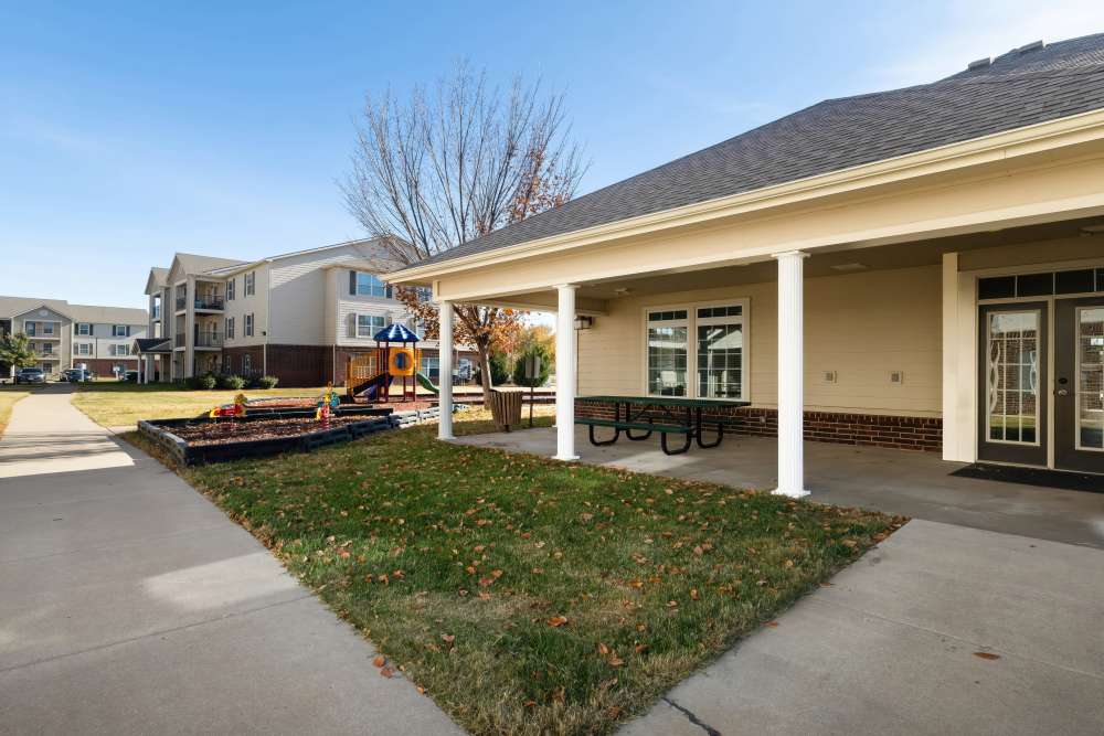 Exterior shot with outdoor seating space at Sunnydale Pointe in Wichita, Kansas