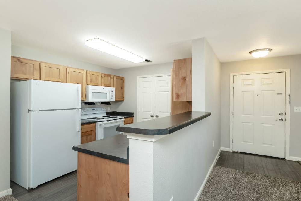 Kitchen with breakfast bar and energy-efficient appliances at Sunnydale Pointe in Wichita, Kansas
