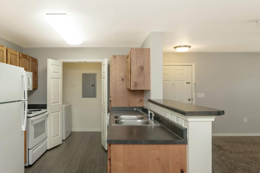 Well-designed kitchen with white appliances at Sunnydale Pointe in Wichita, Kansas