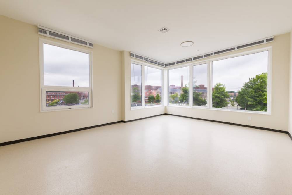Brightly lit and open living room with a glass windows atIsland Parkside in Lawrence, Massachusetts
