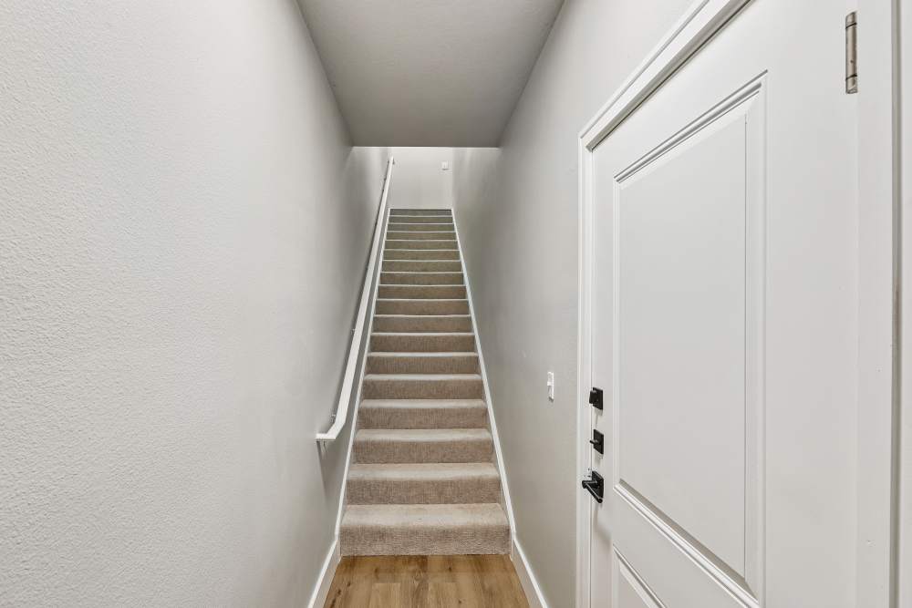 Bright and inviting laundry area leading to a charming bedroom at The Walton in Sanford, Florida.
